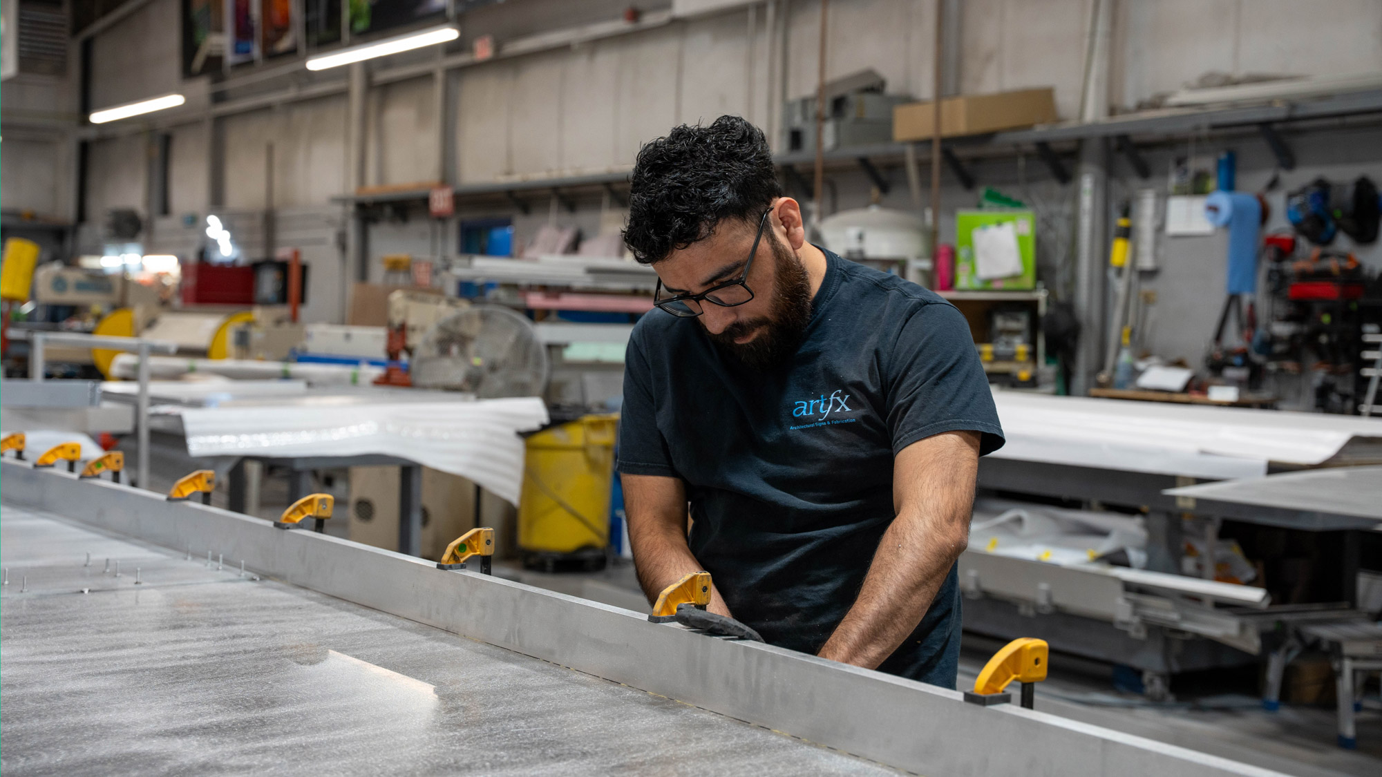ARTfx team member fabricating an architectural sign in the shop