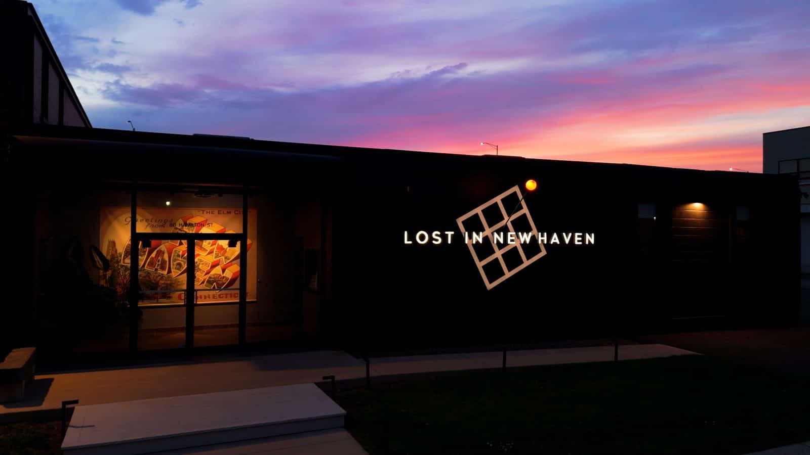 The Lost in New Haven exterior identity sign glowing at dusk, with friction-fit channel letters, a floating grid, and a glowing orb on a 54-inch pin, fabricated by ARTfx